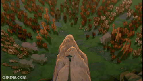 A Lion Is Sitting On Top Of A Rocky Cliff GIF