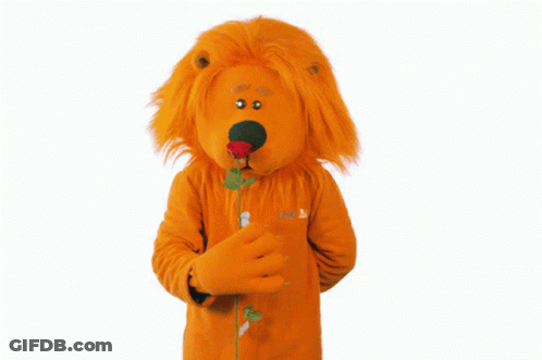 A Lion Mascot Is Holding A Rose In His Hand GIF