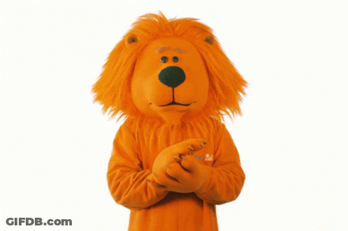 A Lion Mascot Is Wearing An Orange Sweater With The Word Abc On The Sleeve GIF