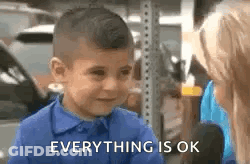 A Little Boy In A Blue Shirt Is Crying While Talking To A Woman And Says `` Everything Is Ok '' . GIF