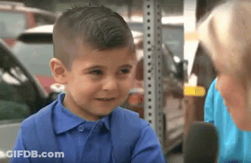 A Little Boy In A Blue Shirt Is Talking To A Woman GIF