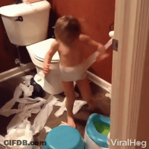 A Little Boy In A Diaper Is Playing With Toilet Paper GIF