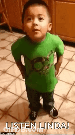 A Little Boy In A Green Shirt Is Standing On A Tiled Floor And Making A Funny Face . GIF