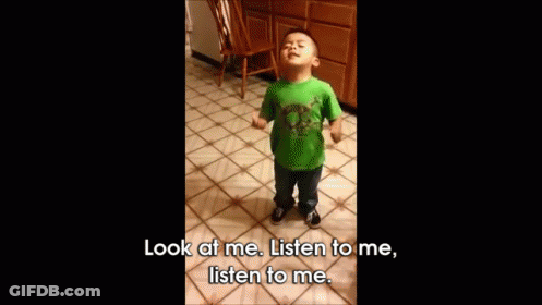 A Little Boy In A Green Shirt Is Standing On A Tiled Floor And Says Look At Me Listen To Me Listen To Me GIF