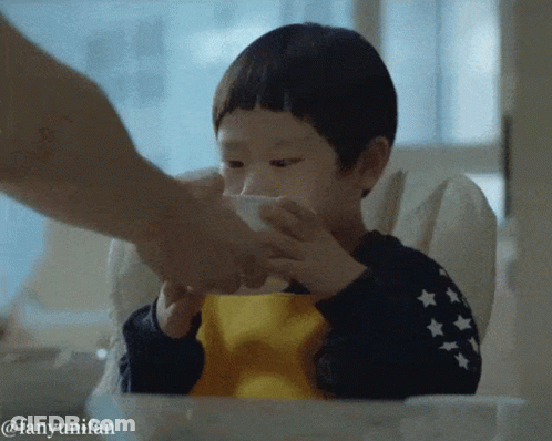 A Little Boy In A High Chair Is Being Fed By A Person With The Hashtag Fanyunifan GIF