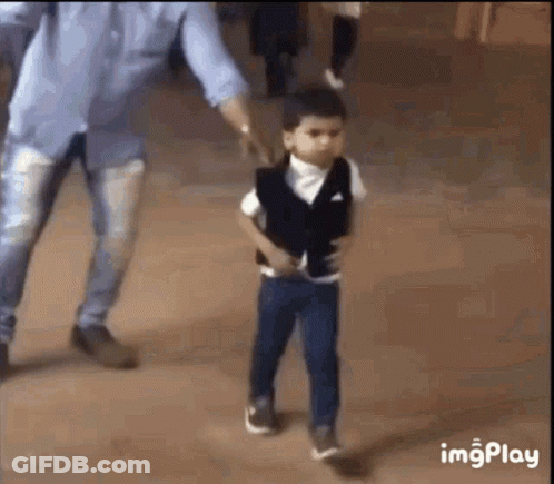 A Little Boy In A Suit Is Walking With His Father . GIF