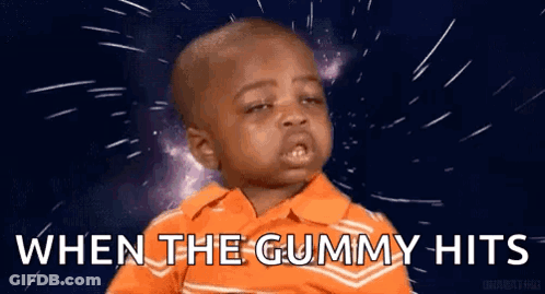 A Little Boy In An Orange Shirt Is Making A Funny Face And Saying `` When The Gummy Hits `` . GIF