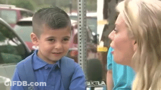 A Little Boy Is Being Interviewed By A Woman With A Microphone That Says Ktla On It GIF