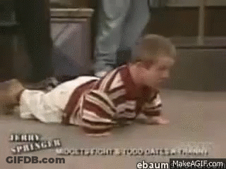 A Little Boy Is Crawling On The Floor With His Legs Crossed . GIF
