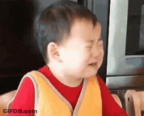 A Little Boy Is Crying In Front Of A Microwave . GIF