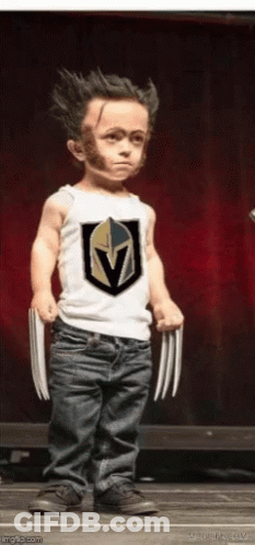 A Little Boy Is Dressed As Wolverine And Is Holding Claws GIF
