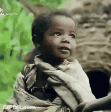 A Little Boy Is Holding A Person 'S Hand . GIF