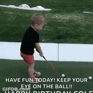 A Little Boy Is Playing Golf With A Golf Club On A Green . GIF