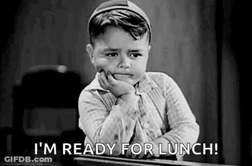 A Little Boy Is Sitting At A Desk With His Hand On His Chin And Saying `` I 'M Ready For Lunch ! '' GIF