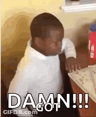 A Little Boy Is Sitting At A Table With The Words `` Damn !!! '' Written On The Screen . GIF