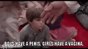 A Little Boy Is Sitting On The Floor Being Touched By A Man . GIF