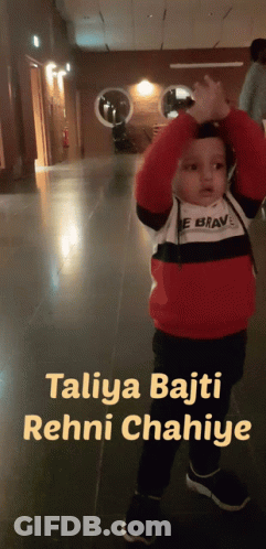 A Little Boy Standing In A Hallway With The Words " Taliya Bajti Rehni Chahiye " Above Him GIF
