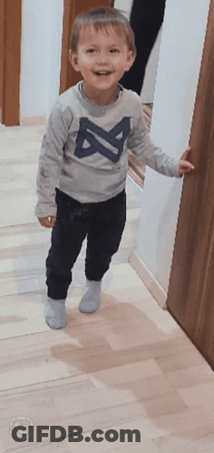 A Little Boy Wearing A Gray Shirt With The Letter A On It GIF