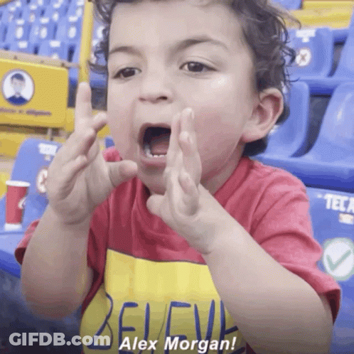 A Little Boy Wearing A Red Shirt That Says Alex Morgan GIF