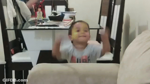 A Little Boy Wearing A Shirt That Says High Is Sitting On A Chair GIF
