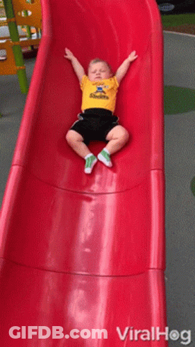A Little Boy Wearing A Steelers Shirt Is Sitting On A Slide GIF