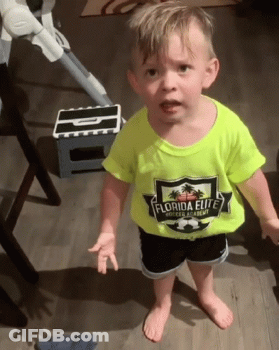 A Little Boy Wearing A Yellow Shirt That Says Florida Elite Is Standing On A Wooden Floor . GIF