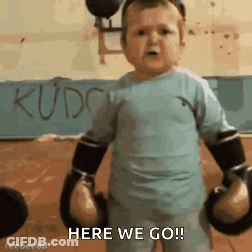 A Little Boy Wearing Boxing Gloves Says Here We Go GIF