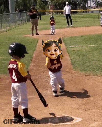 A Little Boy With The Number 4 On His Jersey Is Holding A Bat GIF