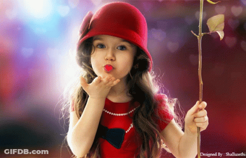 A Little Girl Blowing A Kiss While Holding A Rose In Her Hand GIF