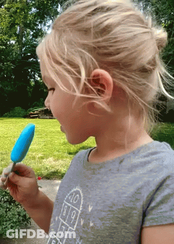A Little Girl Eating A Blue Popsicle Wearing A Shirt With A Hopscotch Pattern GIF