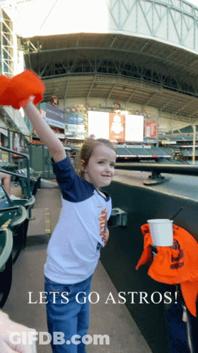 A Little Girl In A Baseball Stadium With The Words Lets Go Astros GIF