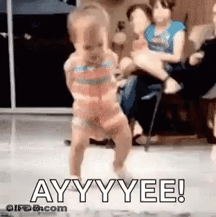 A Little Girl In A Bikini Is Dancing On A Stage . GIF