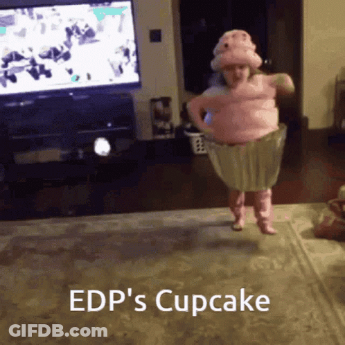 A Little Girl In A Cupcake Costume Jumping In The Air GIF