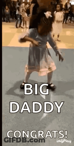 A Little Girl In A Dress Is Dancing In A Room With The Words `` Big Daddy Congrats '' . GIF
