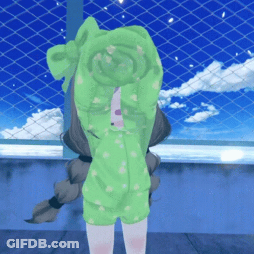 A Little Girl In A Green Outfit Covering Her Face With Her Hands GIF