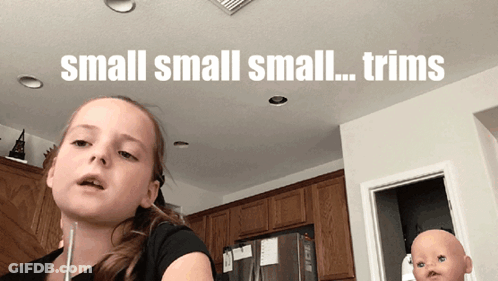 A Little Girl In A Kitchen With The Words Small Small Small Trims On The Ceiling GIF
