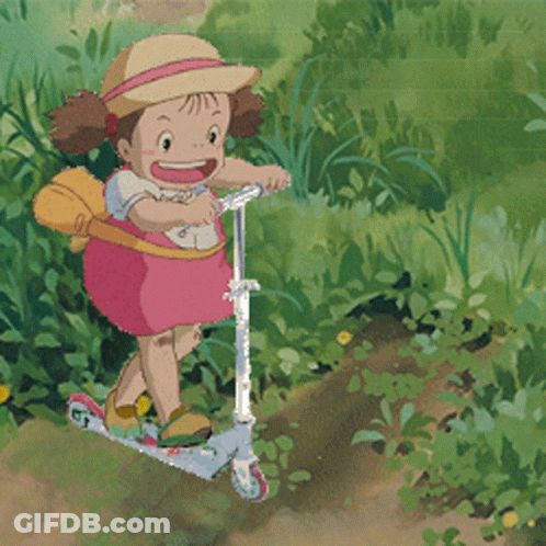 A Little Girl In A Pink Dress Is Riding A Scooter In The Grass GIF