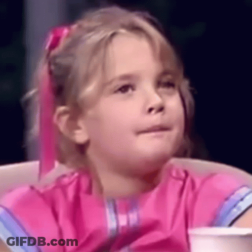 A Little Girl In A Pink Dress Is Sitting In A Chair With A Cup Of Coffee . GIF