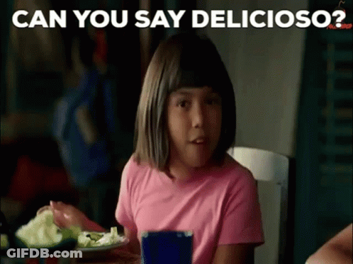 A Little Girl In A Pink Shirt Is Sitting At A Table Eating A Salad . GIF