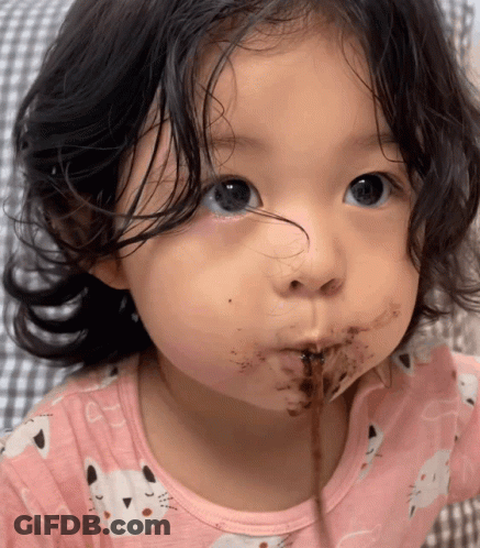 A Little Girl In A Pink Shirt With Cats On It GIF