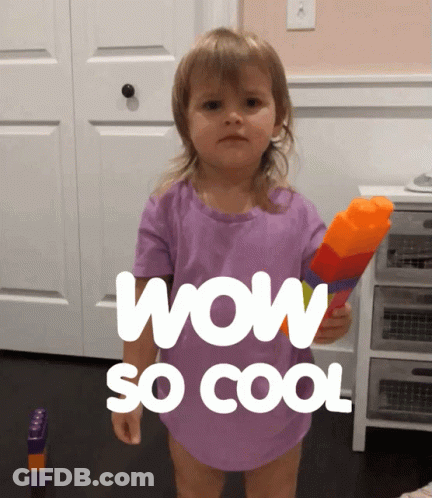 A Little Girl In A Purple Shirt Is Holding A Water Gun And Says Wow So Cool GIF