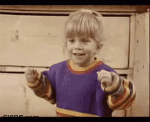 A Little Girl In A Purple Shirt Is Pointing GIF