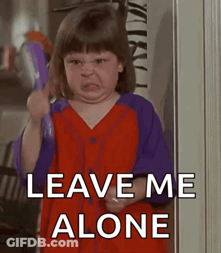 A Little Girl In A Red And Purple Shirt Is Holding A Toy And Saying Leave Me Alone . GIF
