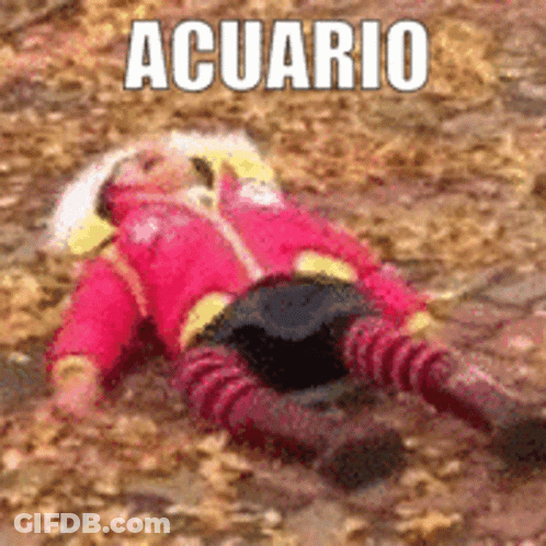 A Little Girl In A Red Jacket Is Laying On The Ground With The Word Acuario Above Her . GIF