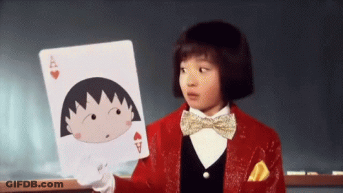 A Little Girl In A Red Suit And Bow Tie Is Holding A Playing Card With A Cartoon Character On It . GIF