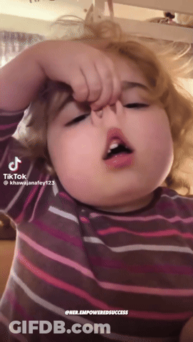 A Little Girl In A Striped Shirt Is Making A Funny Face With A Tiktok Hashtag GIF