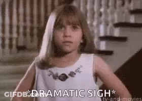 A Little Girl In A White Dress Is Standing In Front Of A Set Of Stairs And Says `` Dramatic Sigh '' . GIF