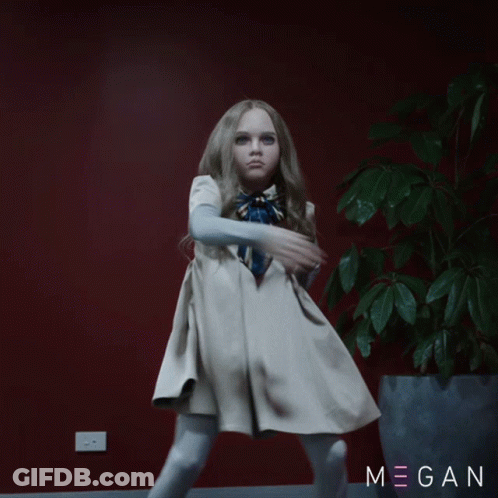 A Little Girl In A White Dress Stands In Front Of A Red Wall And A Potted Plant With The Name Megan On It GIF