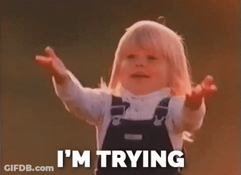 A Little Girl In Overalls Is Standing With Her Arms Outstretched And Saying `` I 'M Trying '' . GIF