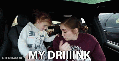A Little Girl Is Being Held By A Woman In A Car And The Words My Driiink Are Above Them GIF